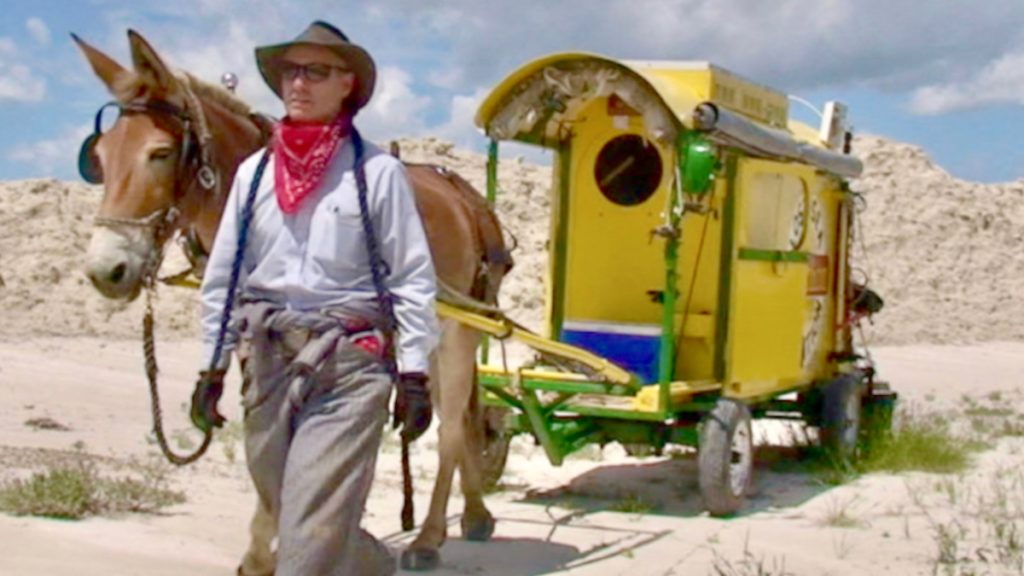 Bernie Harberts and mule Polly with their homemade covered wagon, Lost Sea Expedition