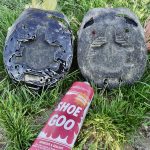 Horse and Mule Travel How To Two worn hoof boots on the grass, one patched with Shoe Goo, beside a tube of Shoe Goo
