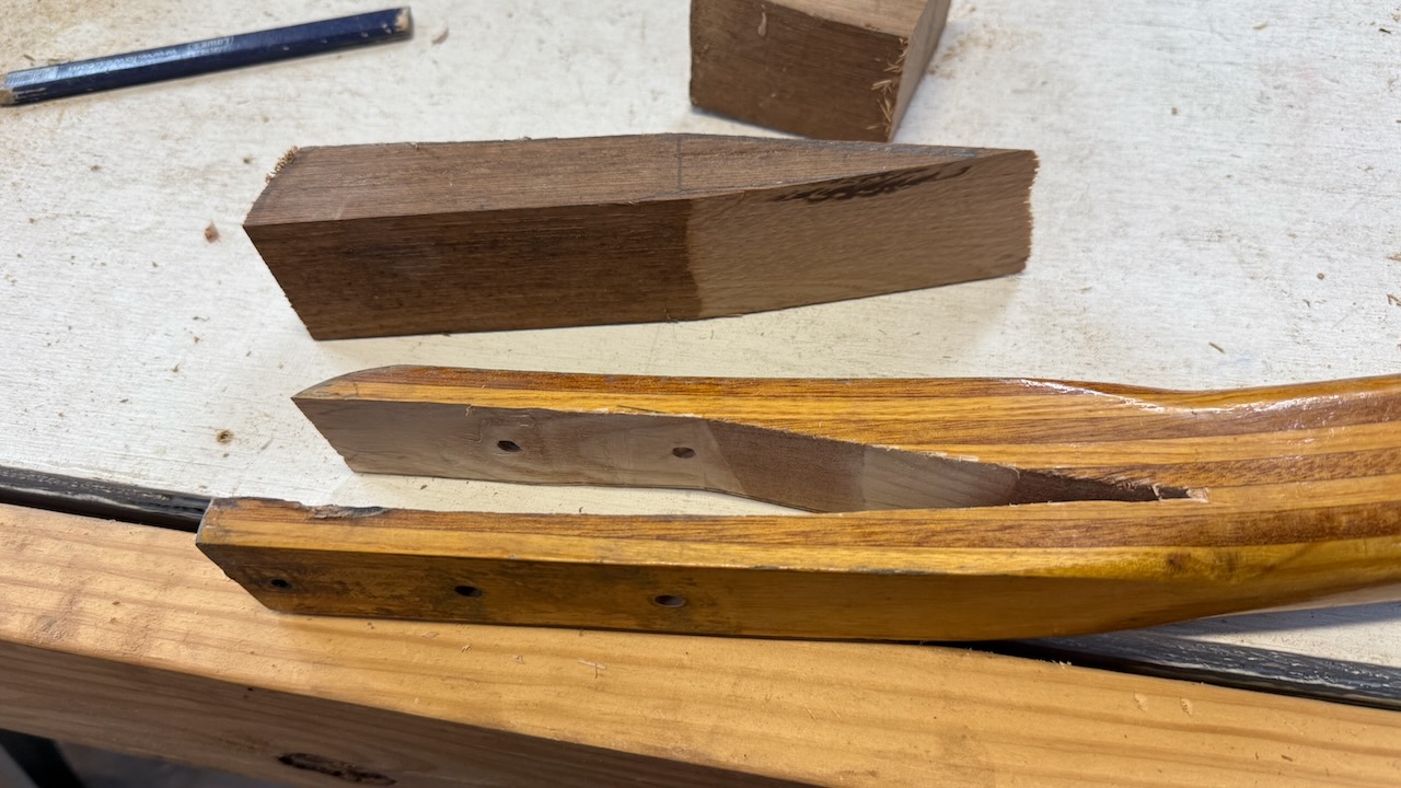 Broken tiller and new laminated wood blank prepped for repair aboard the cruising sailboat Grit